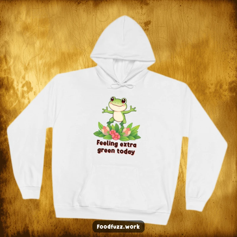 Funny frog hoodie showcasing a gleeful frog leaping over a bountiful spread of fresh green vegetables, highlighting a love for healthy, humorous fun.