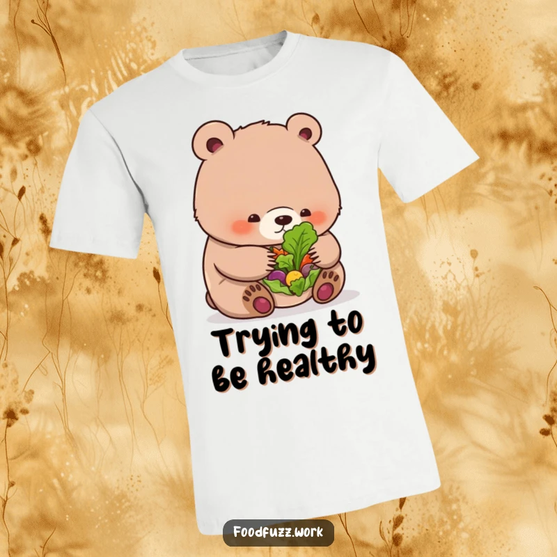 Funny bear cub t-shirt examining a tiny salad leaf, showcasing cute and healthy eating humor.
